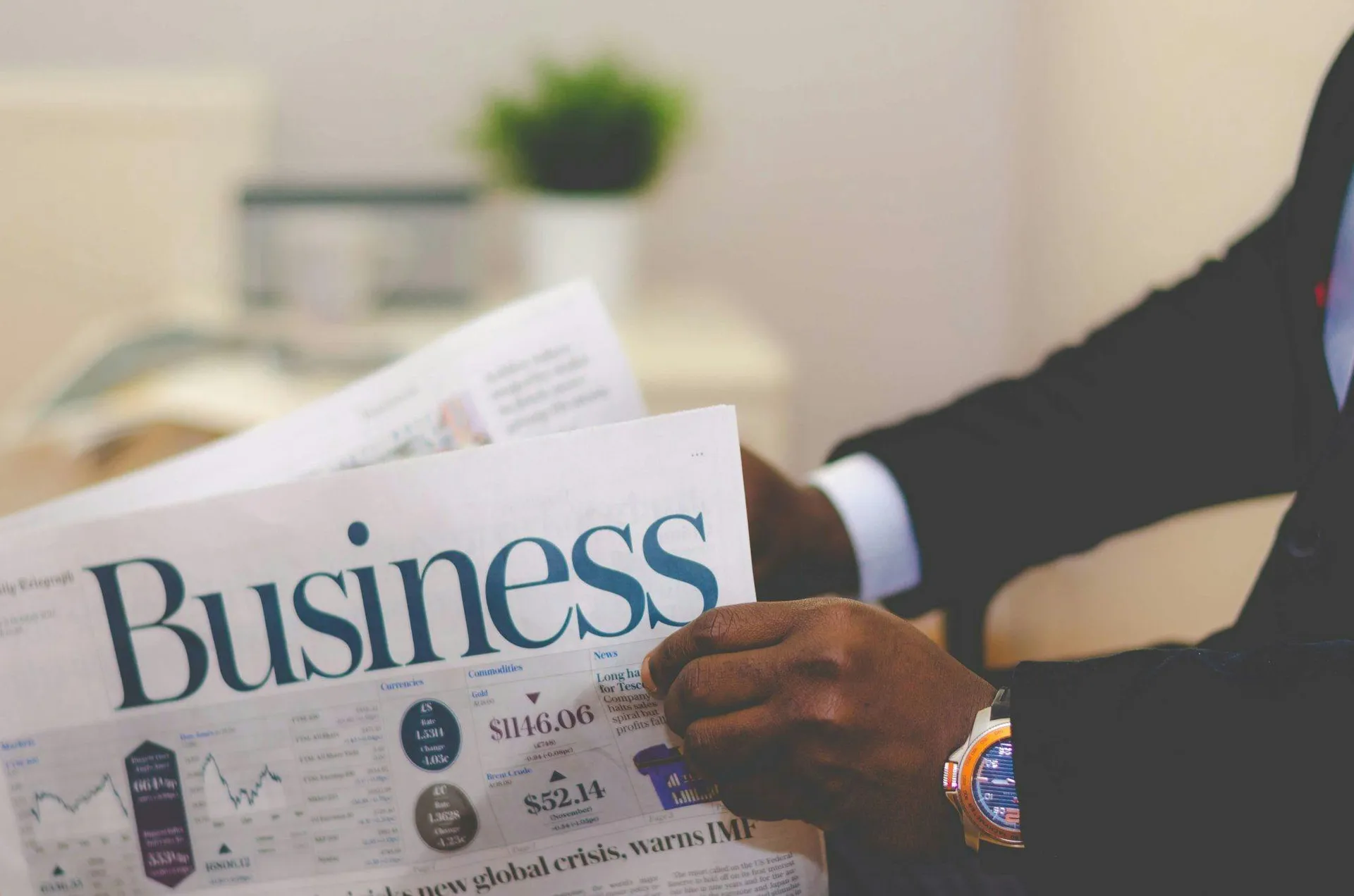 Professional reading a business newspaper